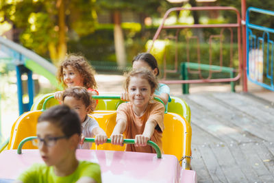 Portrait of smiling girl with people in background