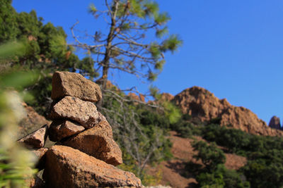 Low angle view of rocks against blue sky