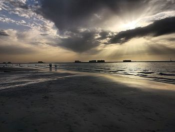 Scenic view of beach against sky during sunset