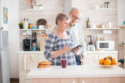 Man and woman having food at home