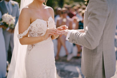Midsection of couple holding hands