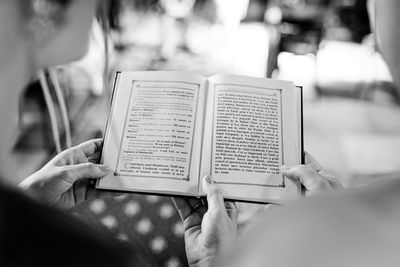 Midsection of woman reading book