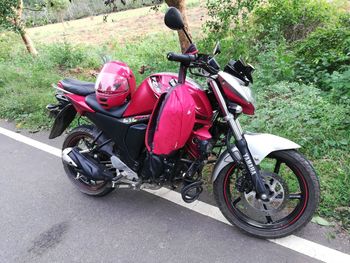 Motor scooter parked on road