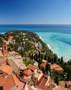 High angle view of townscape by sea against sky