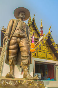 Low angle view of statue against building