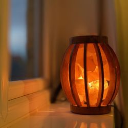 Close-up of illuminated lamp on window sill at home