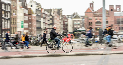 People riding bicycle on city street