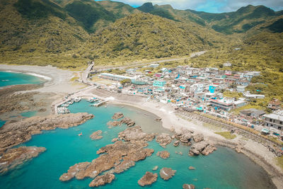 High angle view of sea and buildings in city