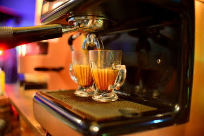 Close-up of coffee cup being field on coffee machine