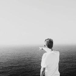 Rear view of man standing on beach