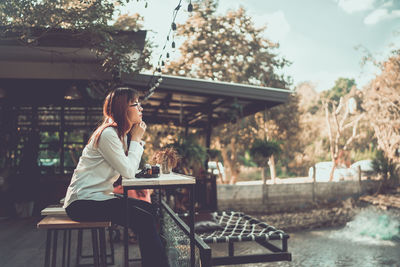 Woman sitting on table at park