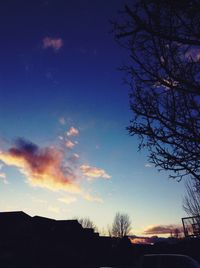 Low angle view of silhouette trees against sky