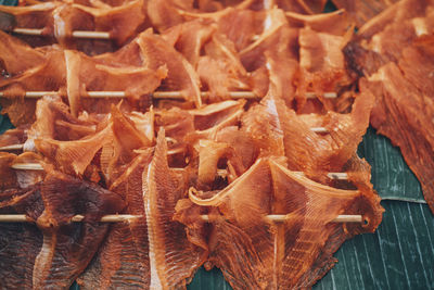 High angle view of dried fish on stick for sale in market