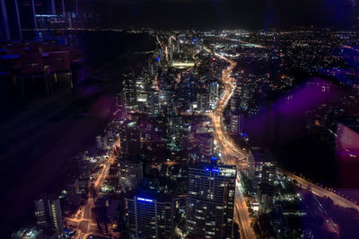 Illuminated surfers paradise seen from window glass at night