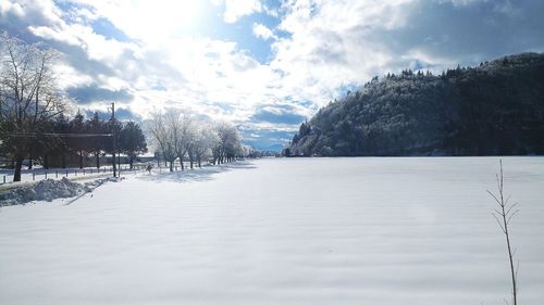 Scenic view of landscape against sky during winter