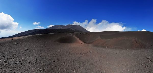 Scenic view of arid landscape against sky