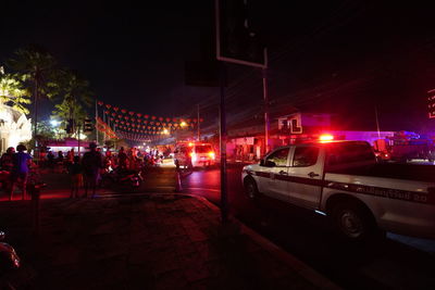 Cars on city street at night