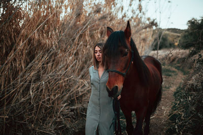 Woman standing by tree on field