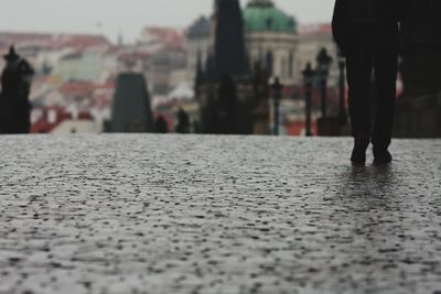 Low section of man walking on street