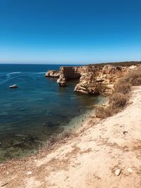 Along the coast - scenic view of sea against clear blue sky