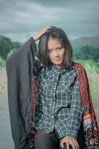 Portrait of smiling young woman standing outdoors