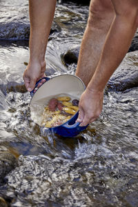 Filling pot with water to cook potatoes