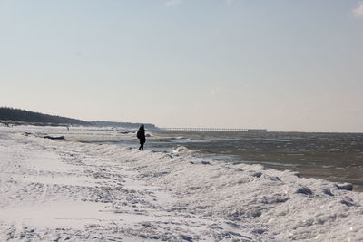 Man on beach against sky