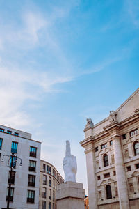 Wide angle view of piazza degli affari in milan with famous artwork in the center, vertical