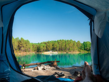 Scenic view of lake against clear blue sky