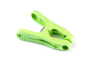 Close-up of green clothespin on white background