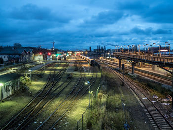 Railroad tracks against cloudy sky