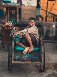 Portrait of happy man sitting on seat