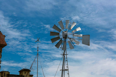 Wind mill turbine in blue sky 