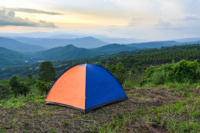 Scenic view of tent on mountain against sky