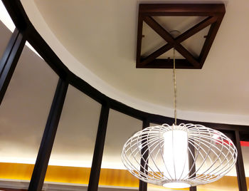 Low angle view of illuminated lamp hanging from ceiling