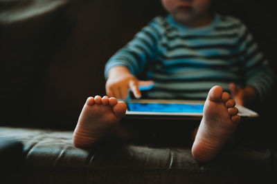 Young child playing with a tablet during isolation in quarantine