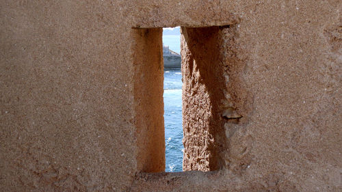 Scenic view of sea against wall