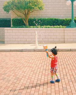 Full length of girl playing outdoors