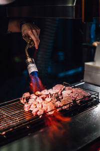 Man preparing food on barbecue grill