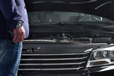 Midsection of man traveling in car