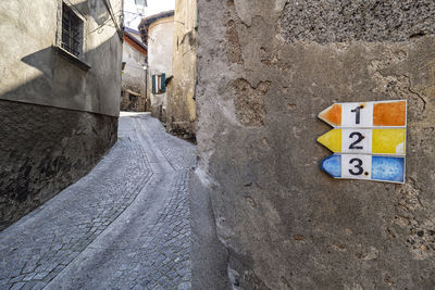 Road sign on wall of building