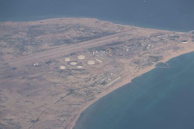 High angle view of land and sea against sky