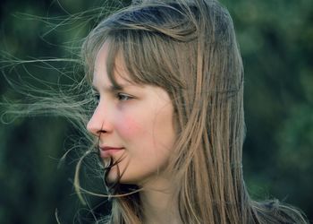 Close-up of thoughtful teenage girl with tousled hair