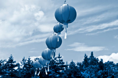 Low angle view of lighting equipment against sky