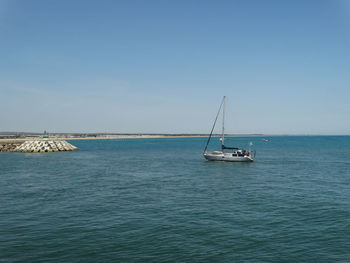 Ship sailing in sea against clear sky