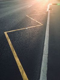 High angle view of arrow symbol on road in city