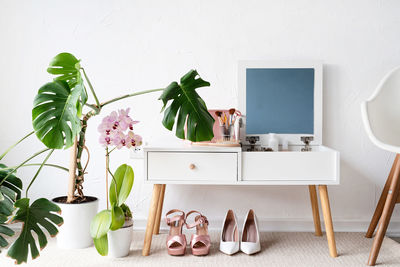 Stylish room interior with elegant dressing table and plants