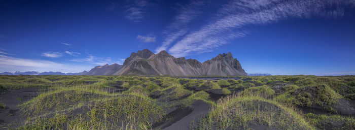 Panoramic view of landscape against blue sky