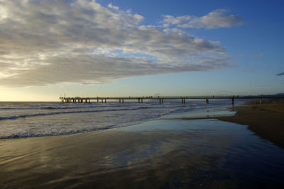 Scenic view of beach against sky during sunset