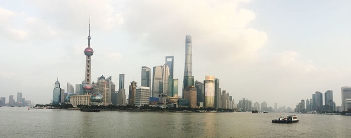 Panoramic view of buildings in city against sky